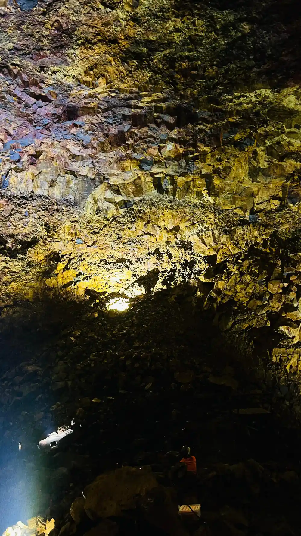 A curtain of yellow rock above the shadowed floor