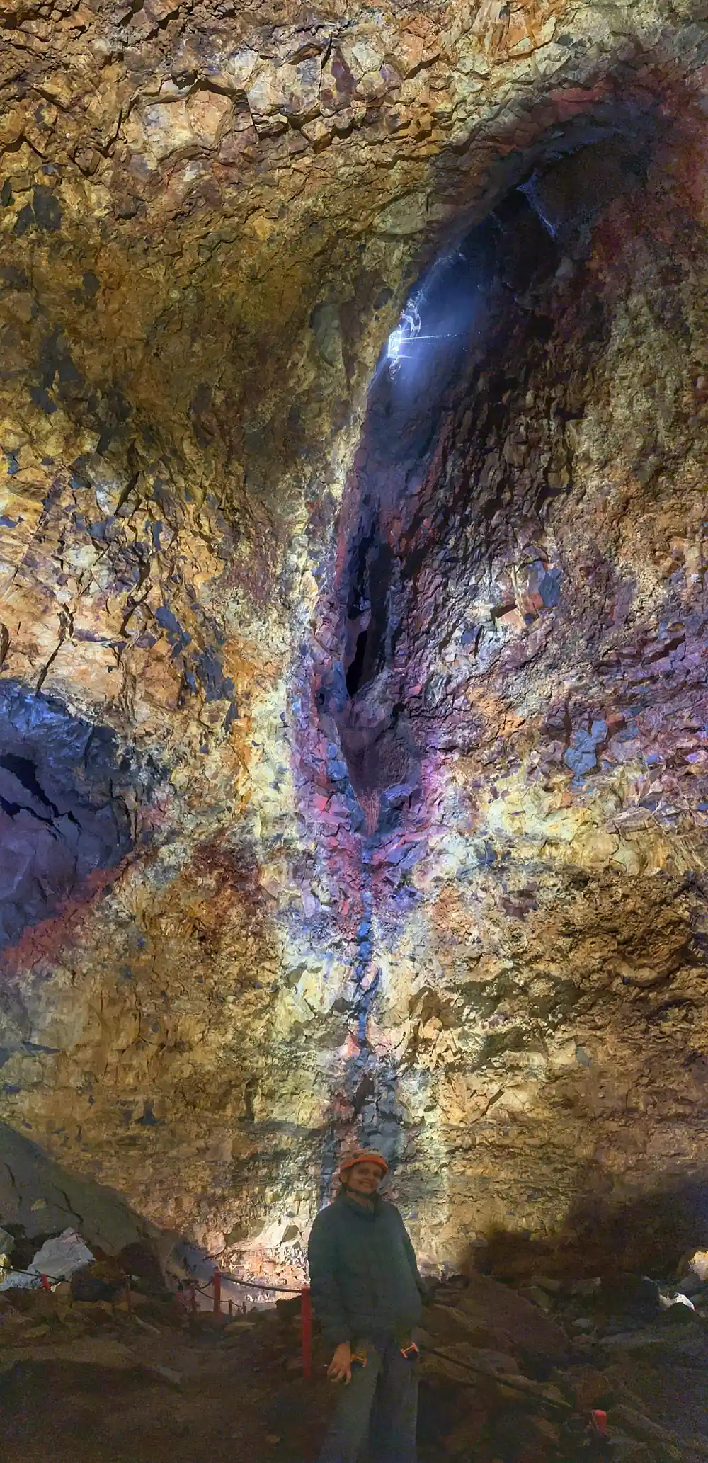 A dark recess in the wall ringed with violet and gold