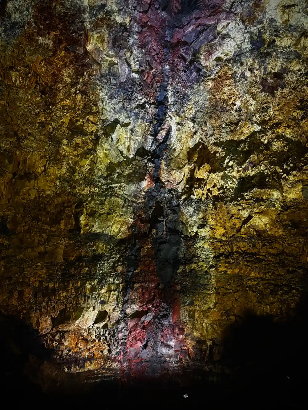 A dark seam running down a wall of sulphur yellow