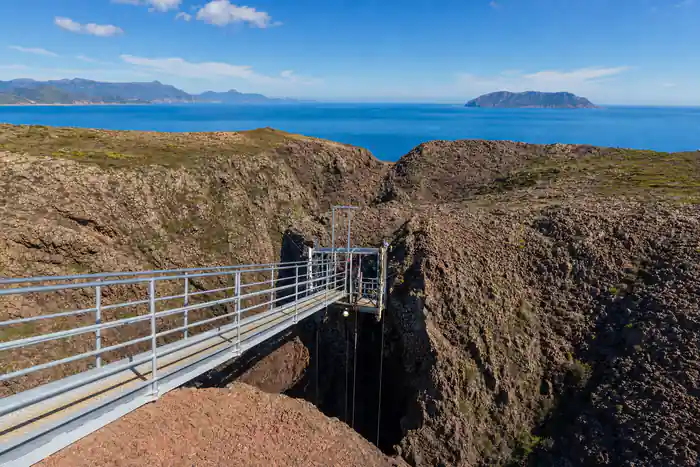The gantry and platform above the crater against the sky