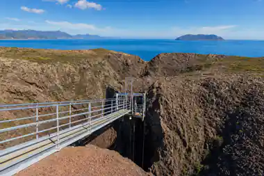 The gantry and platform above the crater against the sky