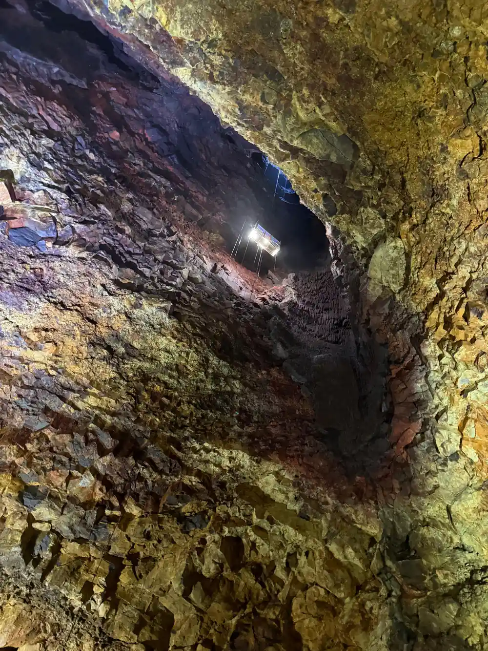 A lamp burning in a hollow of gold and violet rock