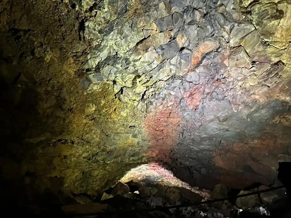 Rough gold and grey rock filling the frame inside the chamber